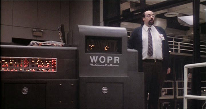 The W.O.P.R. from the movie Wargames; a large mainframe computer with flashing lights and an operator standing nearby.