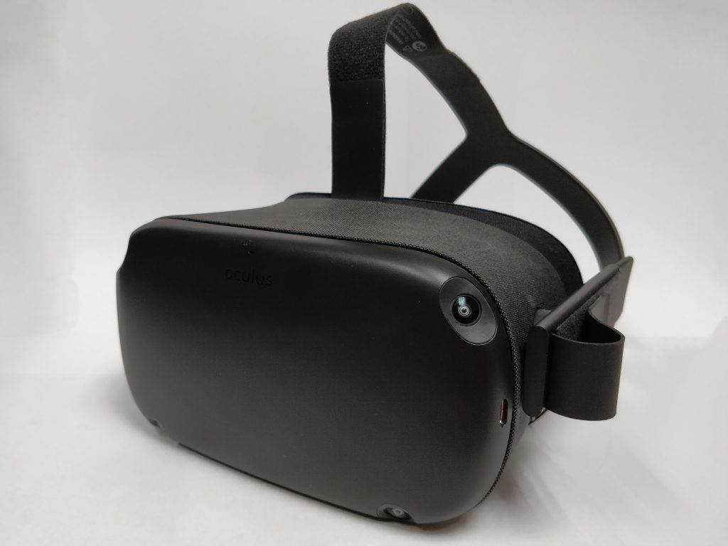 The Oculus Quest headset from the front, showing the charging port, cameras, and headstrap.
