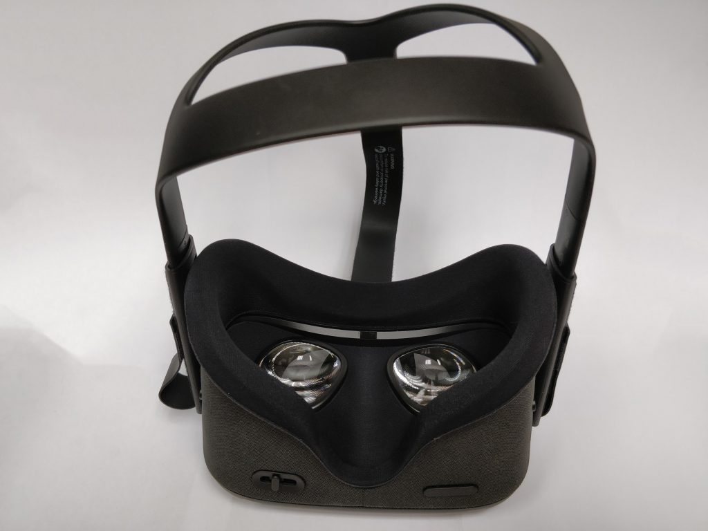 A view of the bottom of the Oculus Quest, showing the lenses inside, the volume button, and the IPD adjustment.