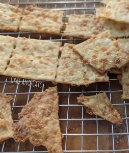 Fresh sourdough cheese crackers cooling on a wire rack.