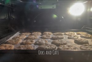 Crackers on a parchment lined baking sheet in an oven, baking.